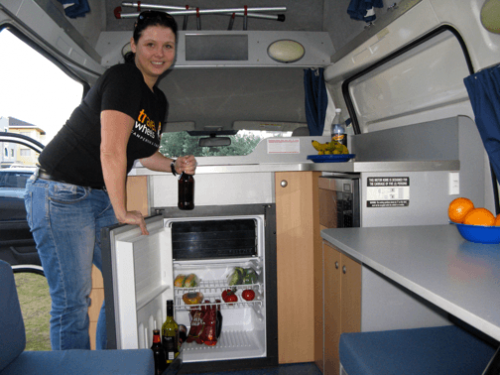 used automatic campervans for sale - lovely lady inside the campervan grabing a beer from the fridge
